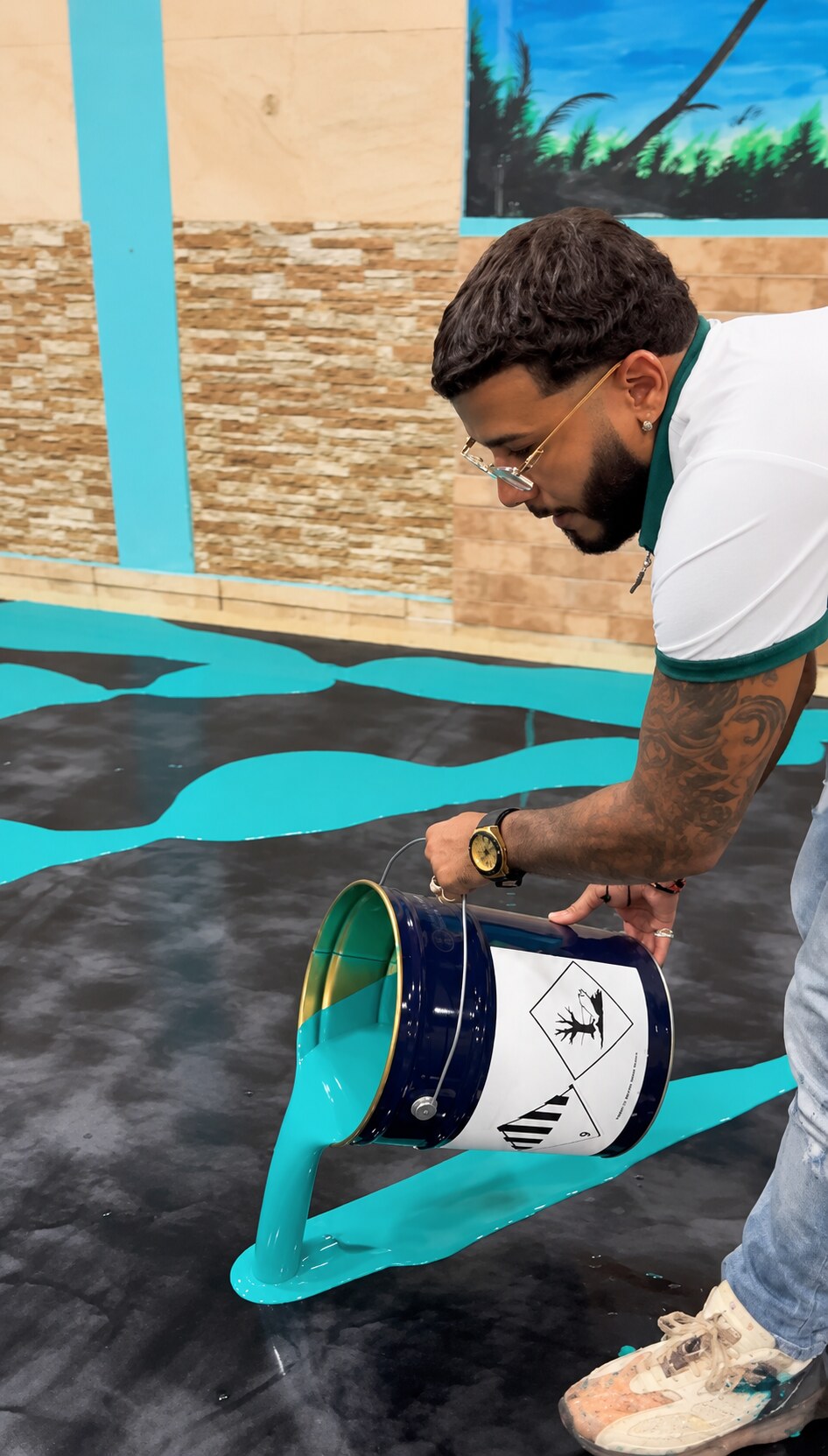 Exotic Resin professional pouring turquoise epoxy onto the floor