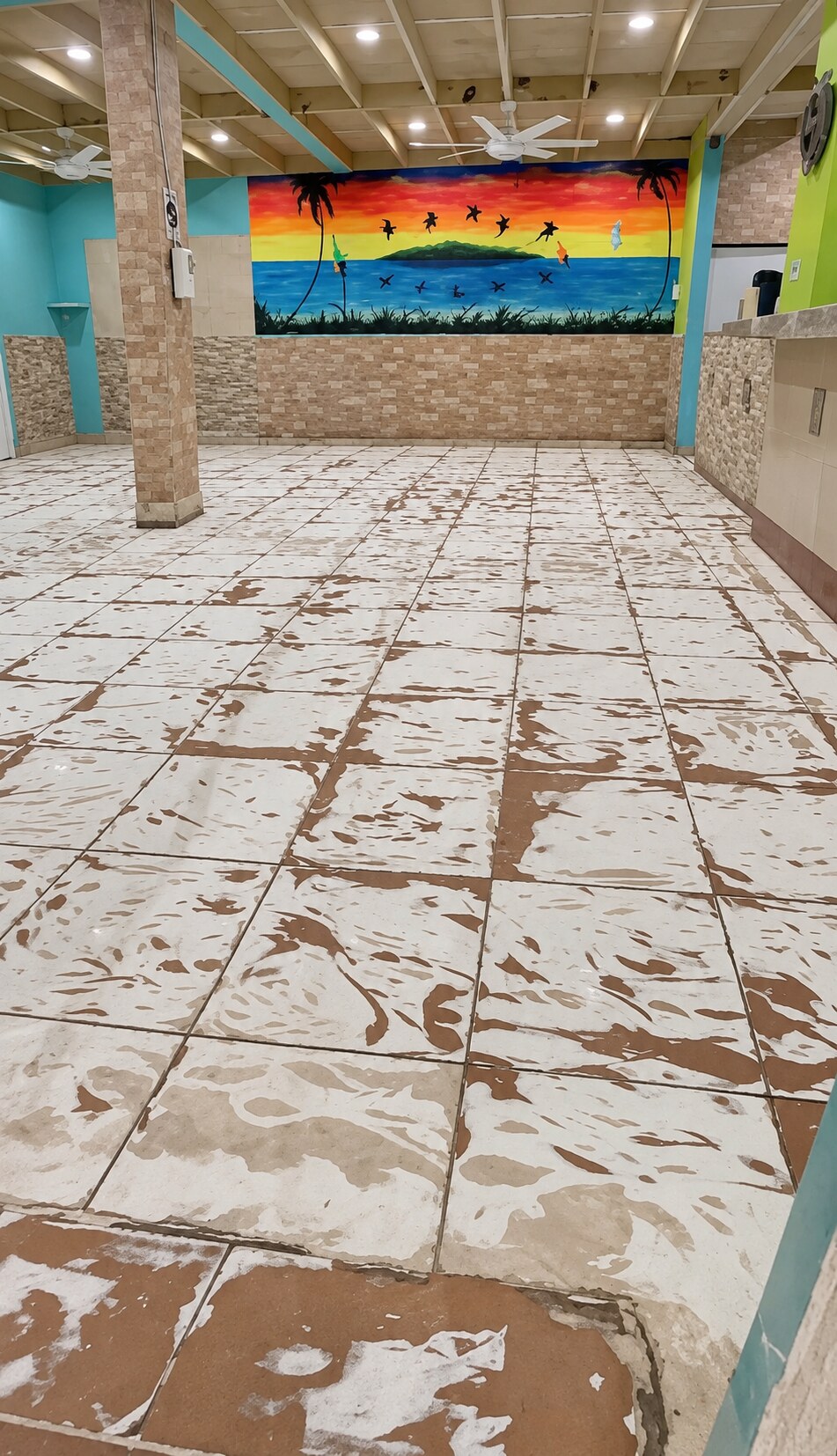 Commercial tile floor prepared for a turquoise metallic epoxy installation